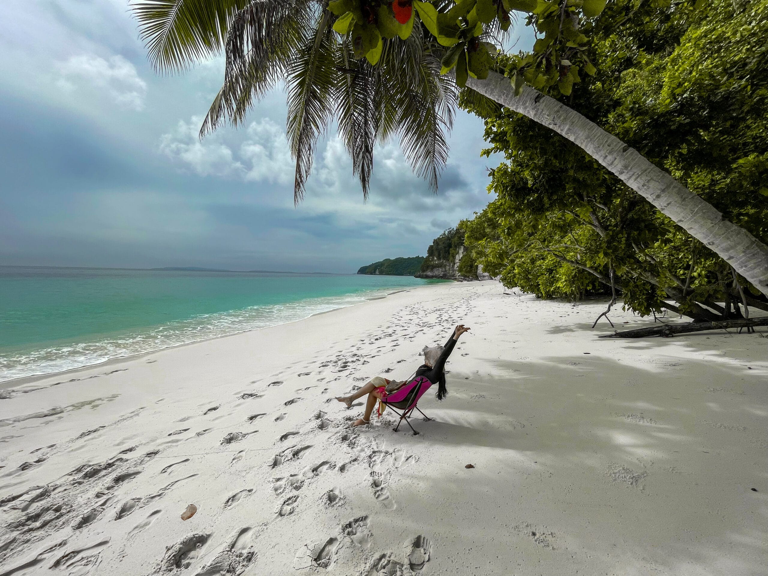 A girl relaxing on a beach on Banggai Islands