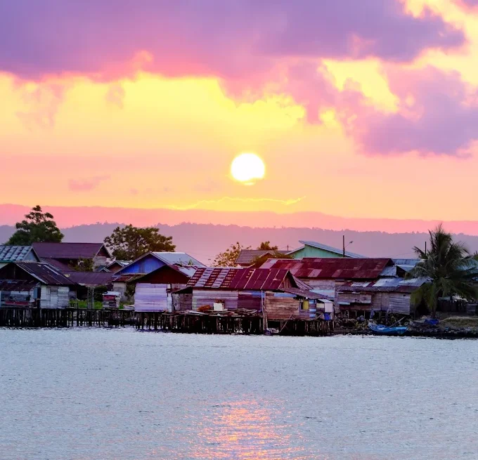 Sunset over a stilt village built on the water near Luwuk, Central Sulawesi