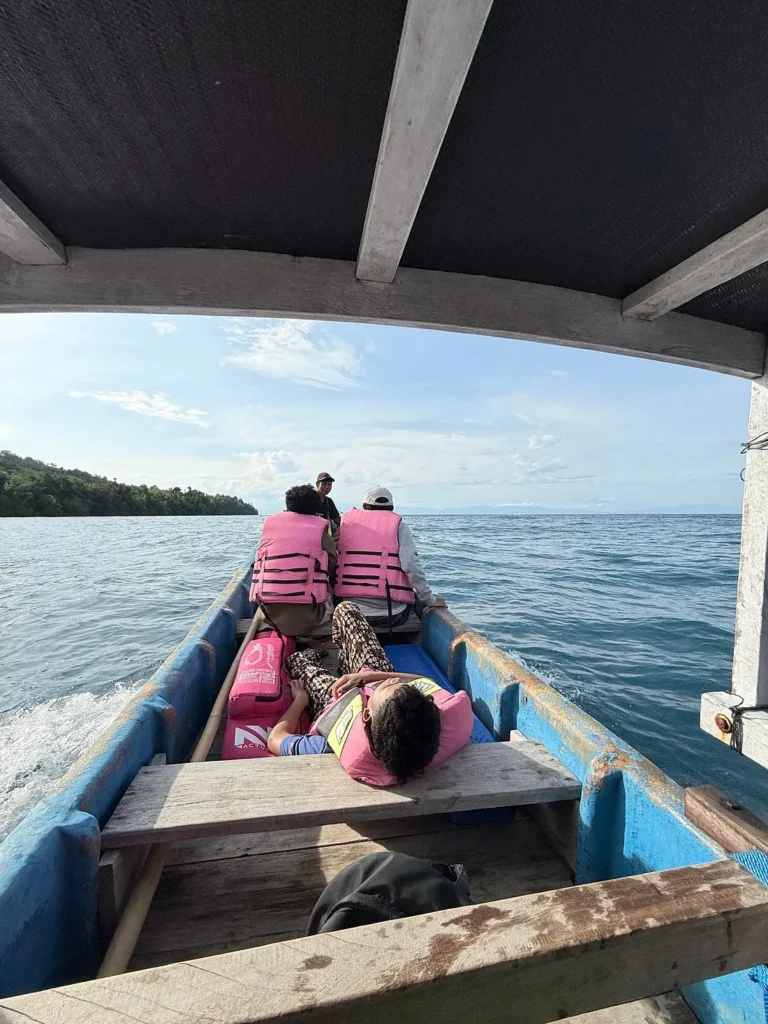 Passengers in life jackets aboard the wooden ferry crossing from Luwuk to the Banggai Islands