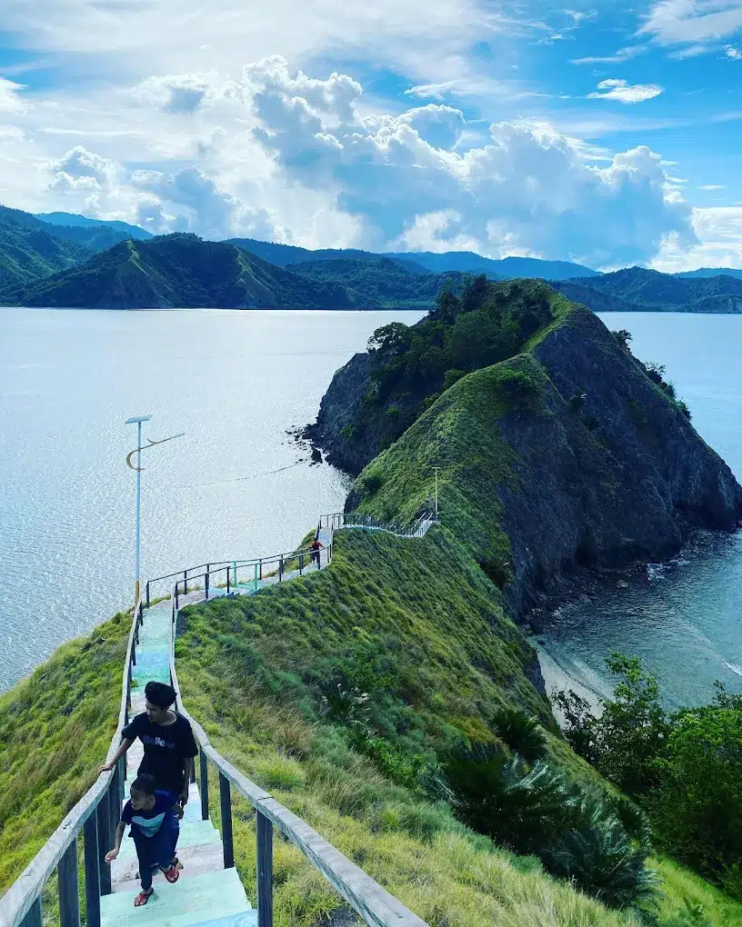 Scenic ridge walk on Pulau Dua island in Luwuk Banggai with stairs overlooking the deep blue ocean.