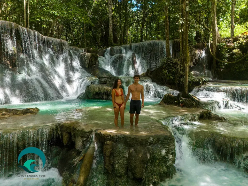 travelers visiting Salodik Waterfall a multi tiered falls in Central Sulawesi