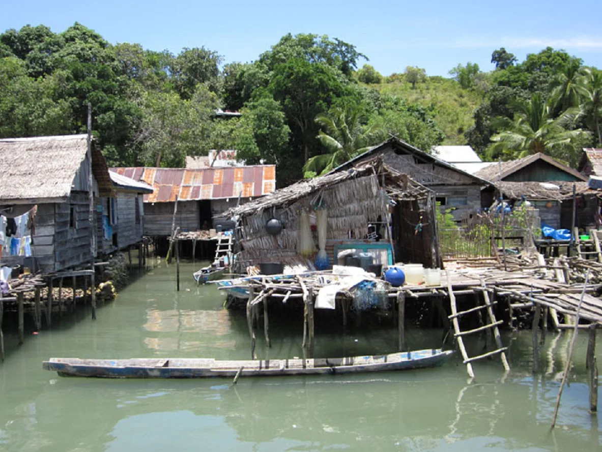 Bajau stilt houses and a dugout canoe in Bokori village, Sulawesi
