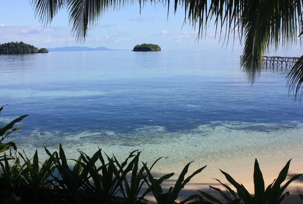 Calm morning sea and small islands seen from the shore of Kadidiri, Togian Islands