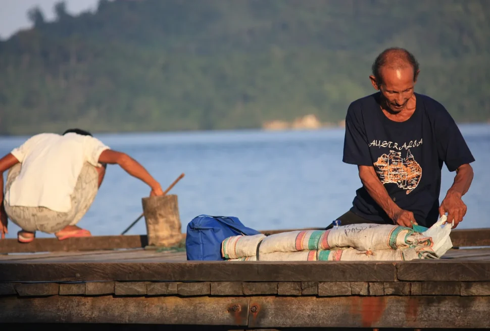 Fishermen working on a boat at Malenge in the Togian Islands