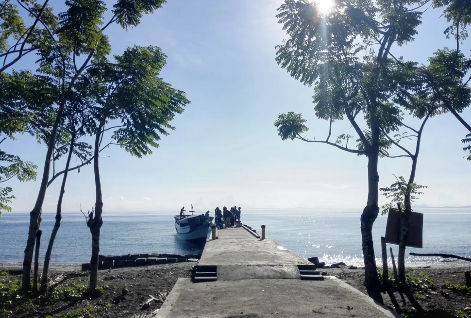 Concrete jetty and trees at the harbour of Una-Una island
